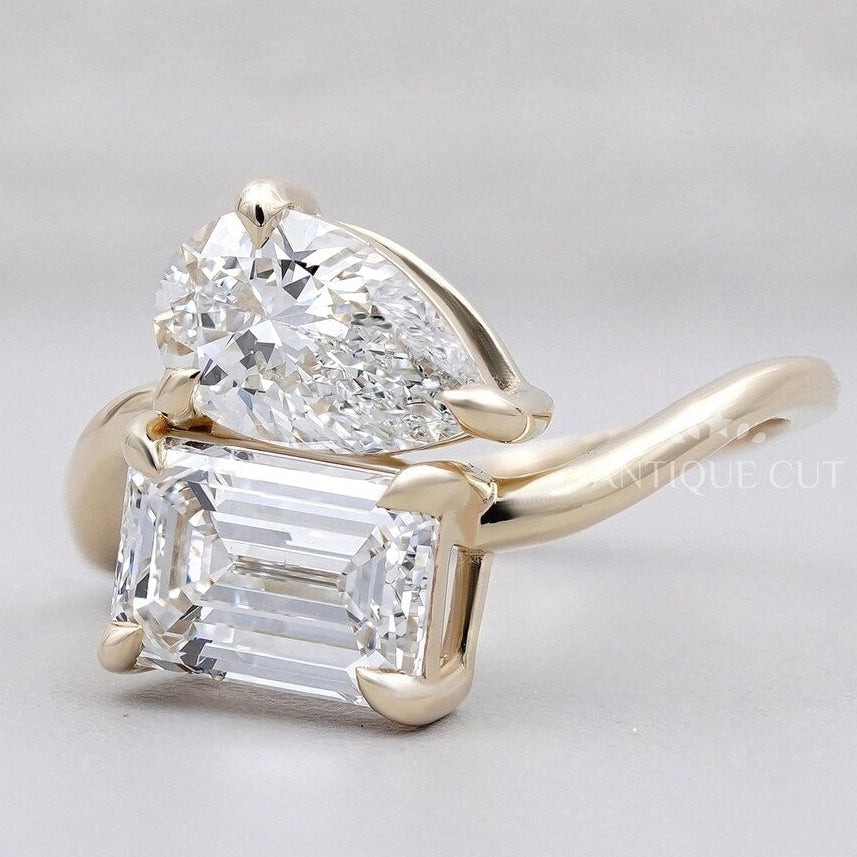 Yellow gold emerald cut ring with pear diamonds