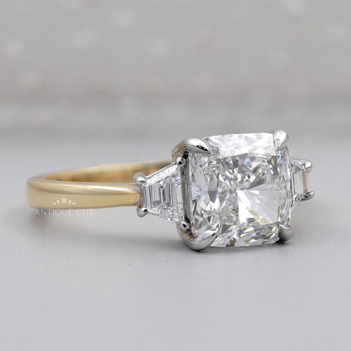 Yellow gold engagement ring with cushion cut center