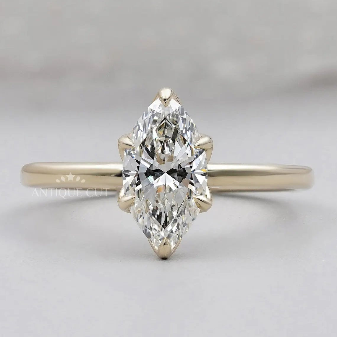 Marquise solitaire engagement ring in yellow gold
