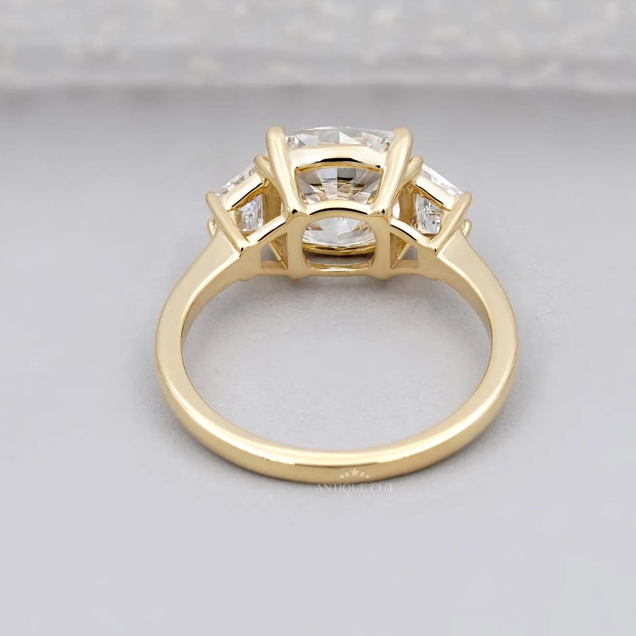 Baguette side stone cushion cut engagement ring in premium metal