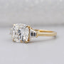 Three stone diamond engagement ring with cushion center diamond