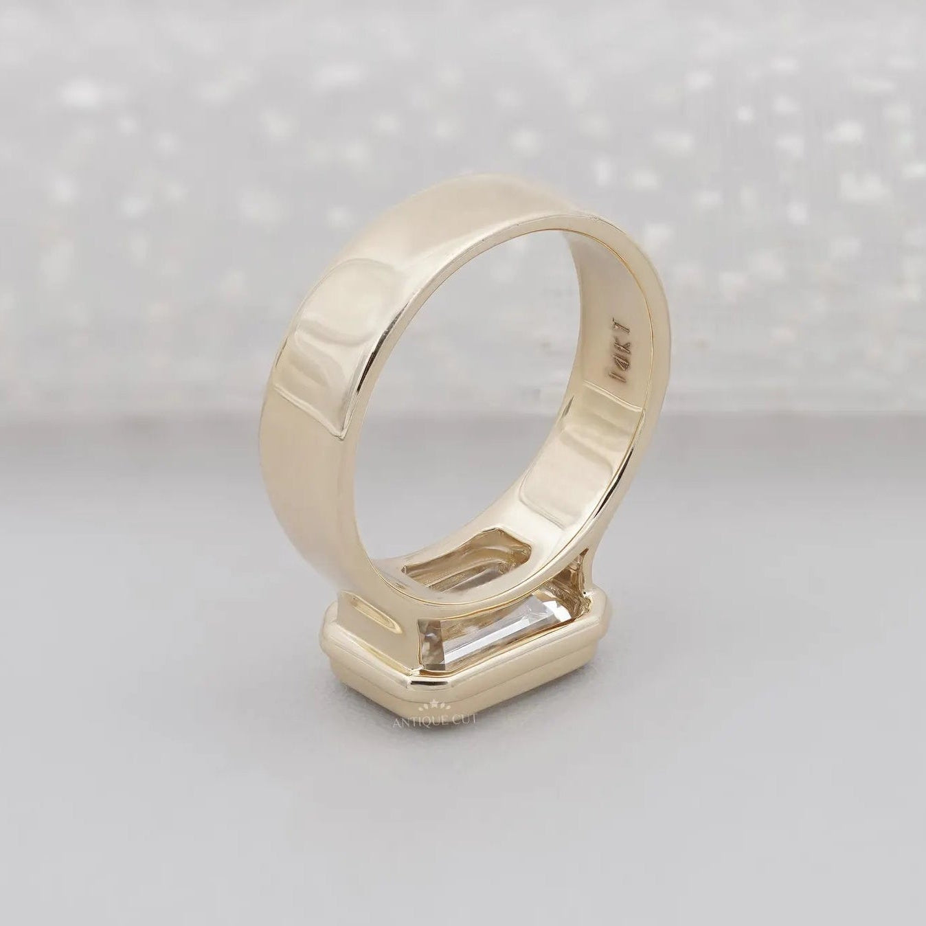 Yellow gold emerald cut diamond ring horizontal set