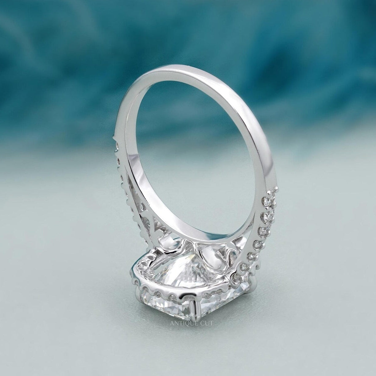 Cushion halo engagement ring in white gold with pave band
