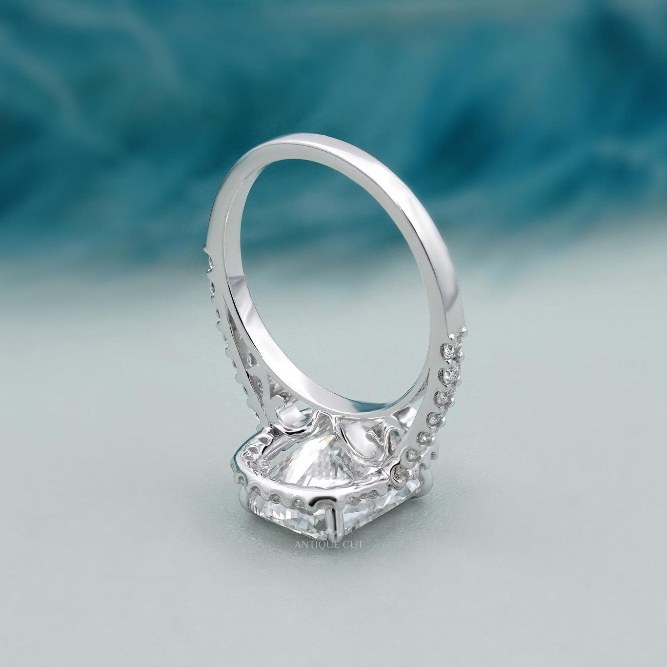 Cushion halo engagement ring in white gold with pave band