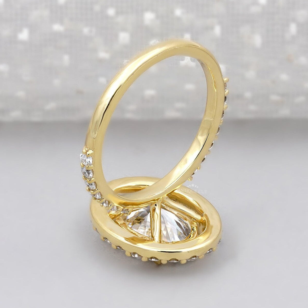 Round halo engagement ring with oval center diamond