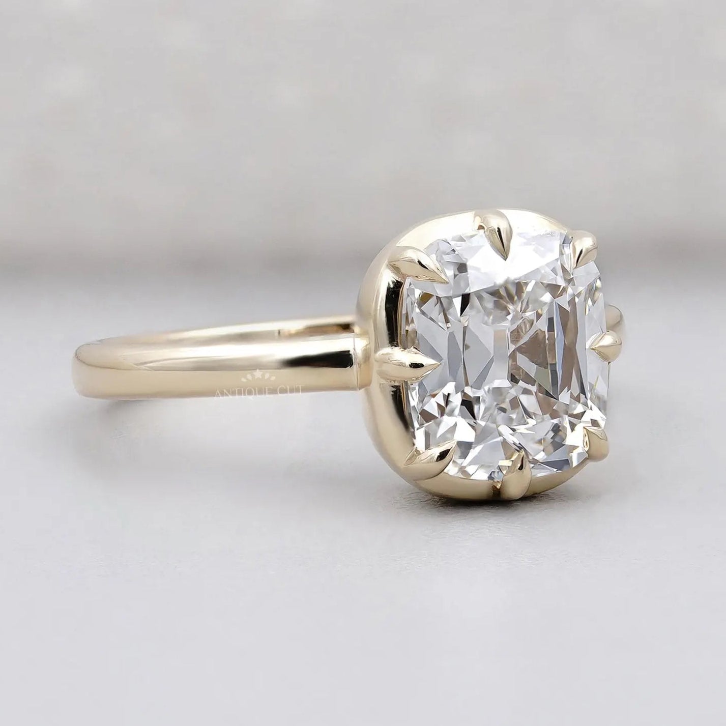 Yellow gold old mine cushion diamond ring with hidden halo