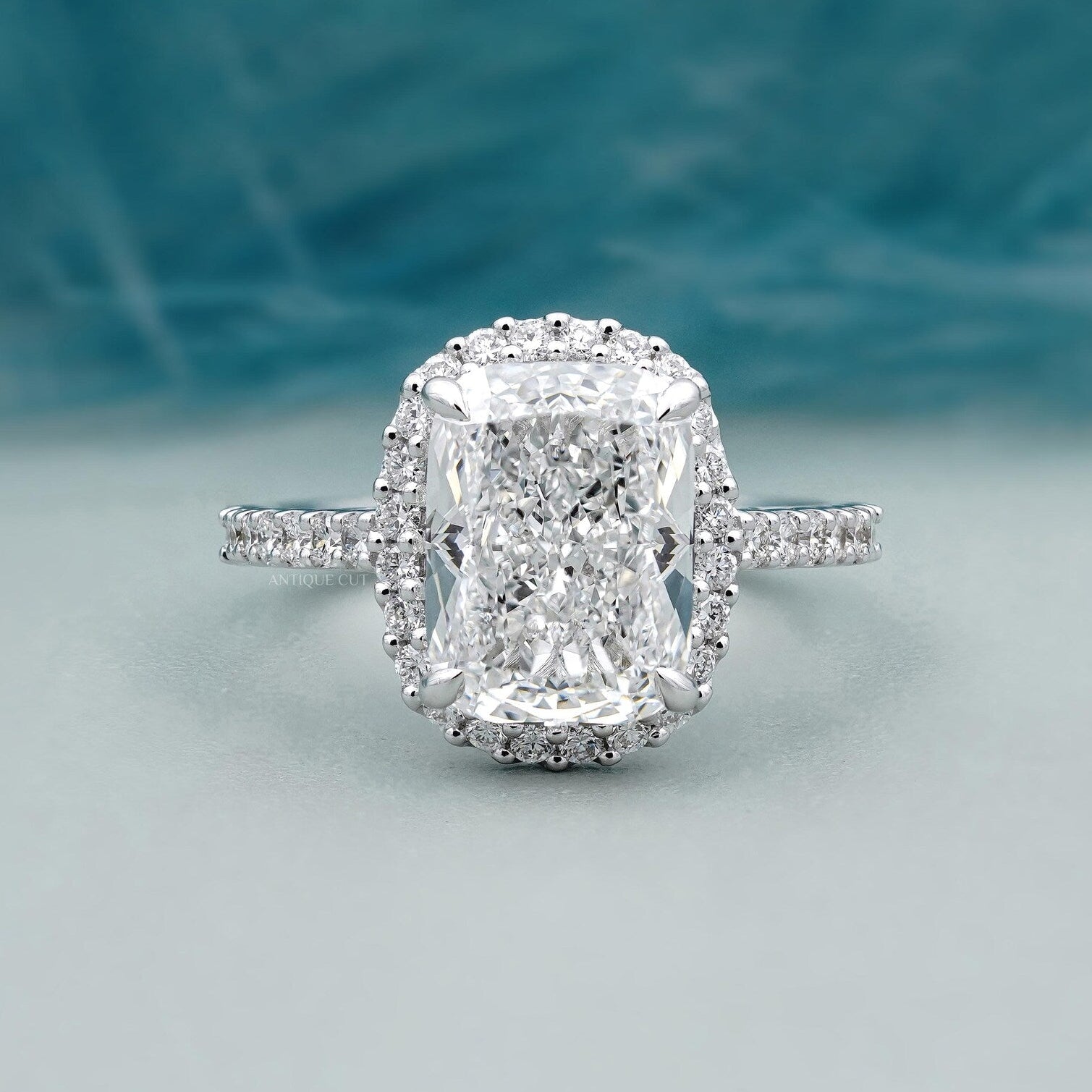 Cushion halo engagement ring in white gold with pave band