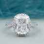 Cushion halo engagement ring in white gold with pave band