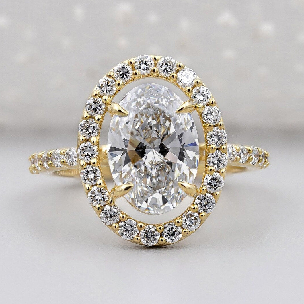 Oval lab grown diamond round halo engagement ring