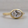 Oval diamond bezel engagement ring with hidden halo