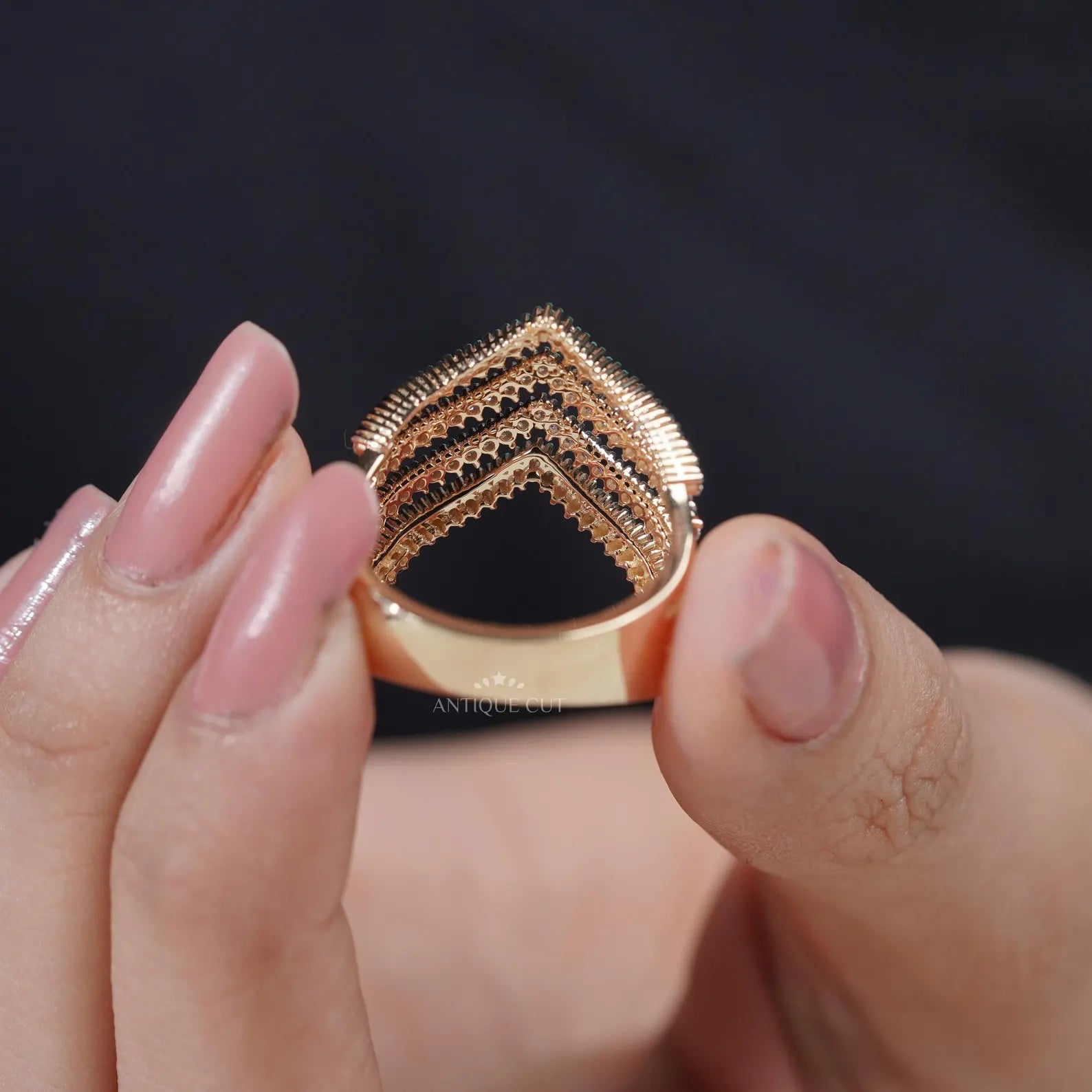 Gold and diamond ring on a light gray background

