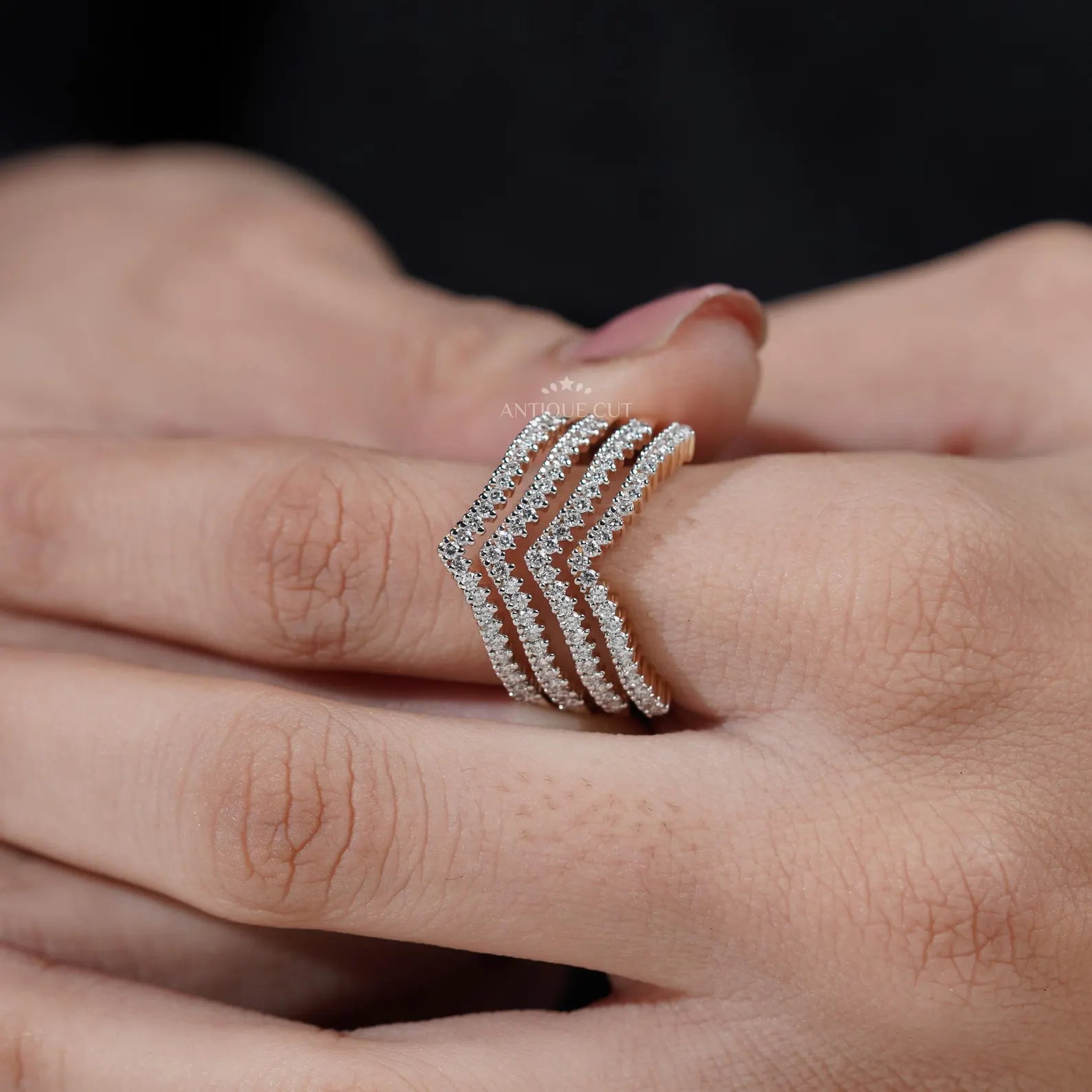 Gold and diamond ring on a light gray background

