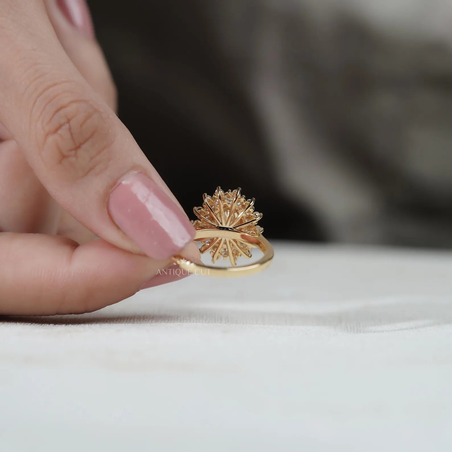 Gold ring with a yellow diamond and smaller diamonds on a white background

