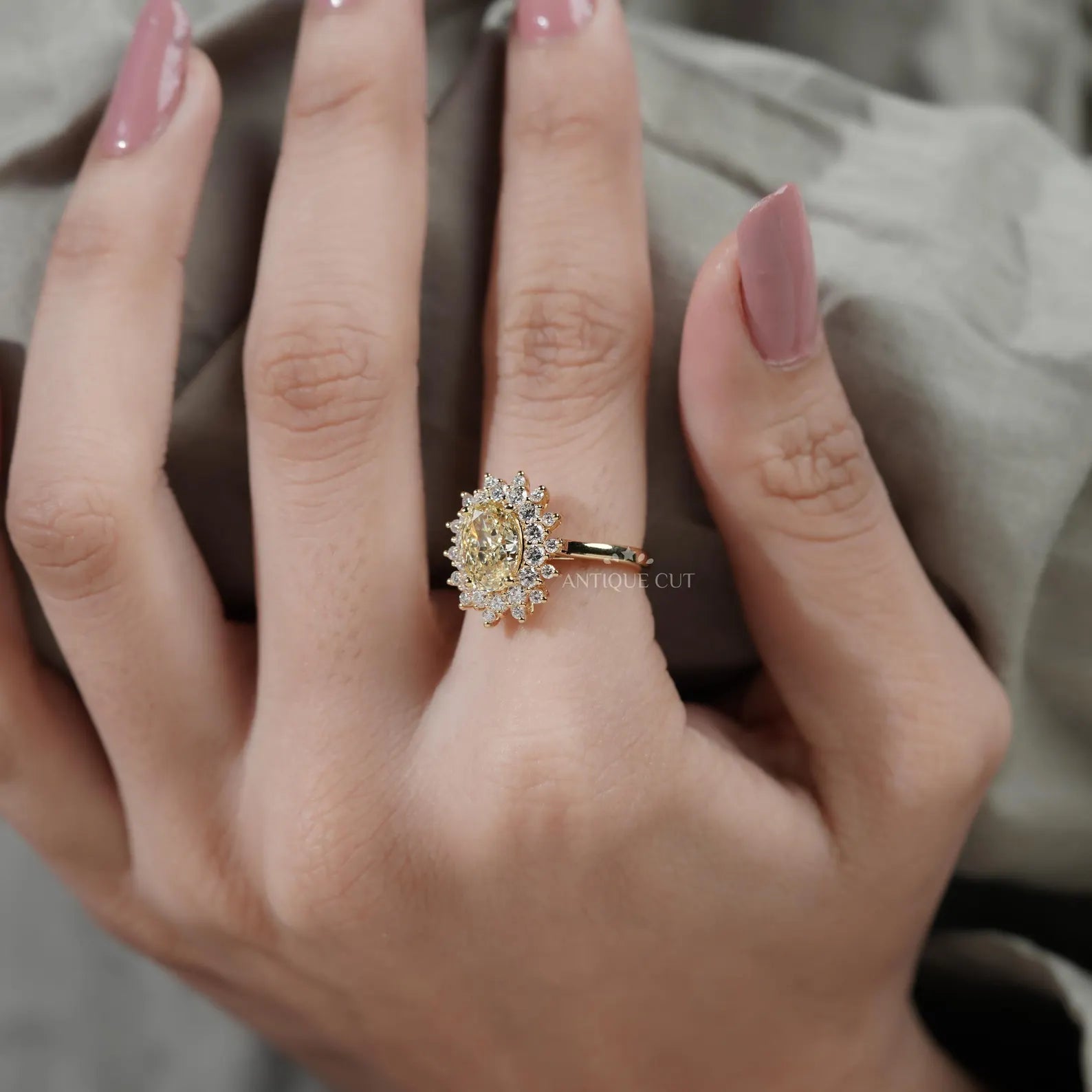 Close-up of a hand wearing a gold ring with a diamond ring