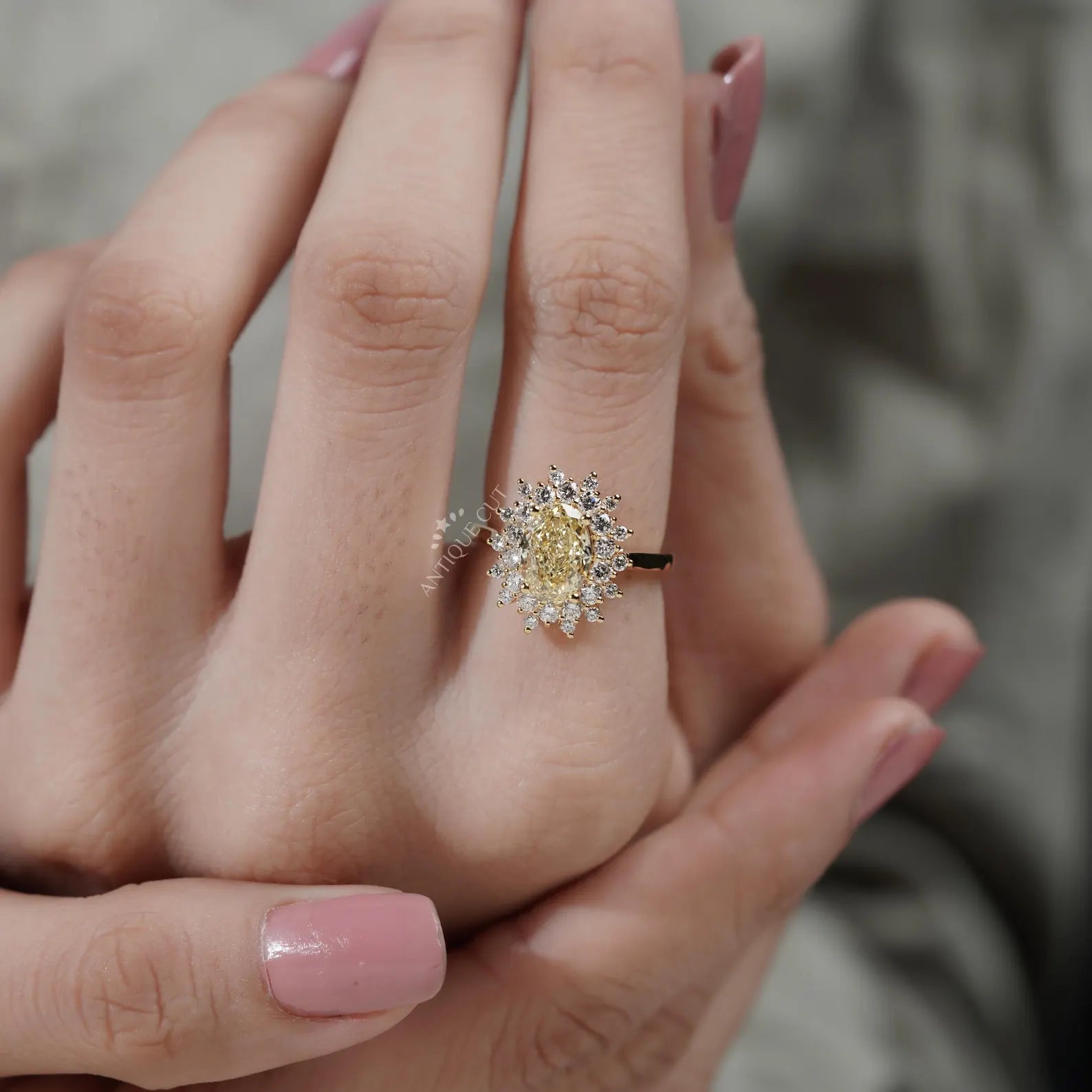 Close-up of a hand wearing a gold ring with a diamond ring