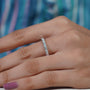 Silver ring with diamonds on a soft blue background

