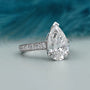 Lab grown pear cut engagement ring with pave band
