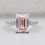 Emerald cut pink diamond solitaire ring with side diamond clusters