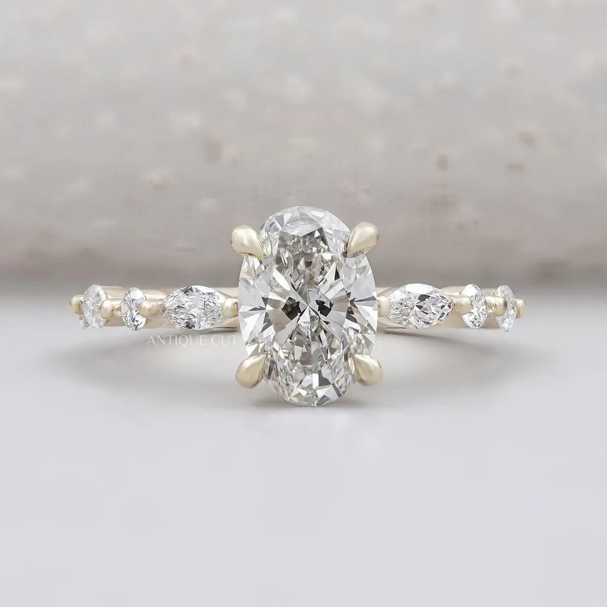 Oval cut wedding ring with marquise side stones