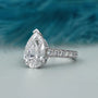 Lab grown pear cut engagement ring with pave band
