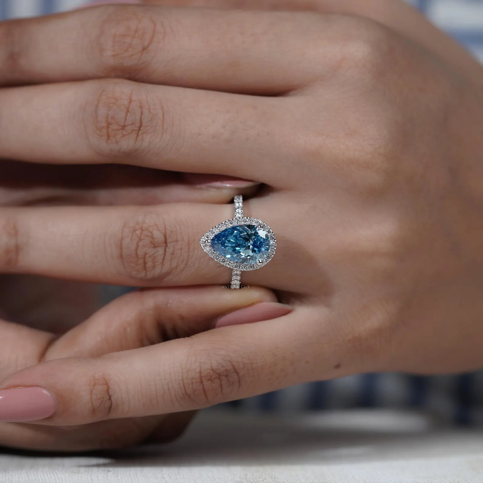 White gold teardrop engagement ring with blue lab grown diamond
