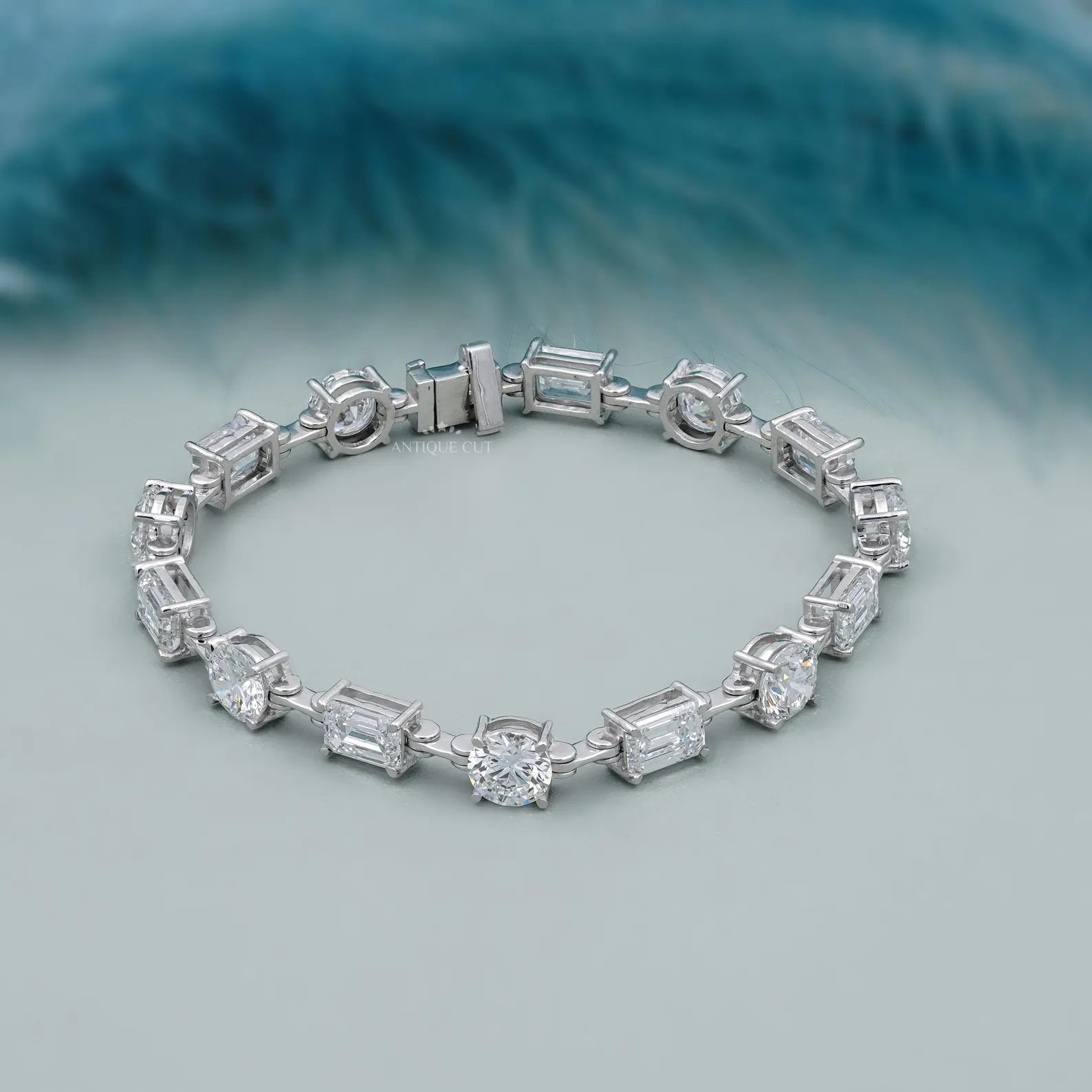 Silver bracelet with diamond accents on a light blue background

