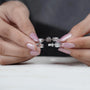 Close-up of hands holding a diamond bracelet