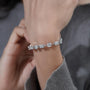 Close-up of hands holding a diamond bracelet