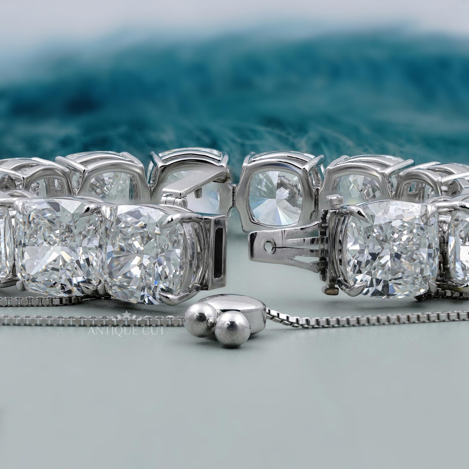 Silver bracelet with large gemstones on a light blue background