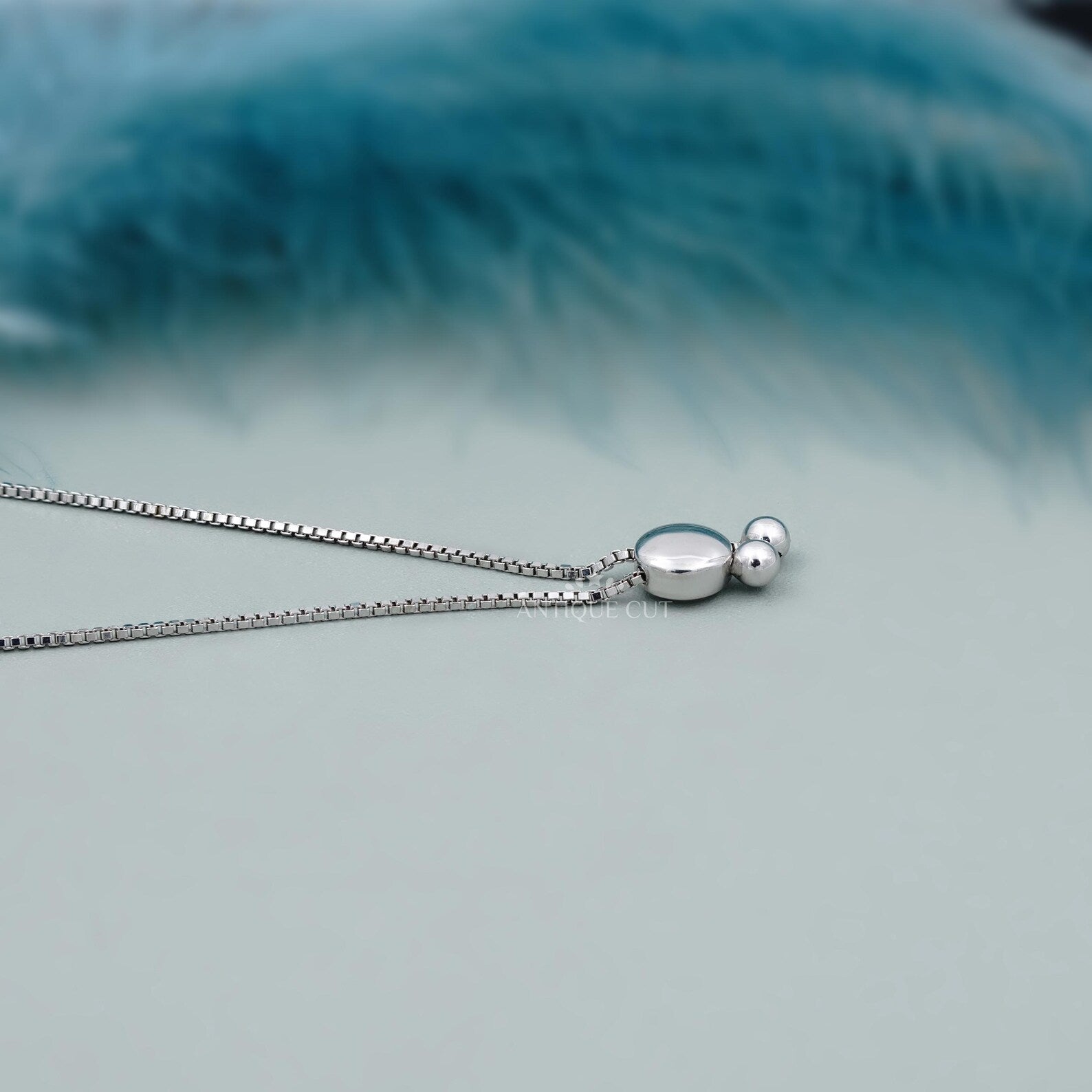 Silver bracelet with large gemstones on a light blue background