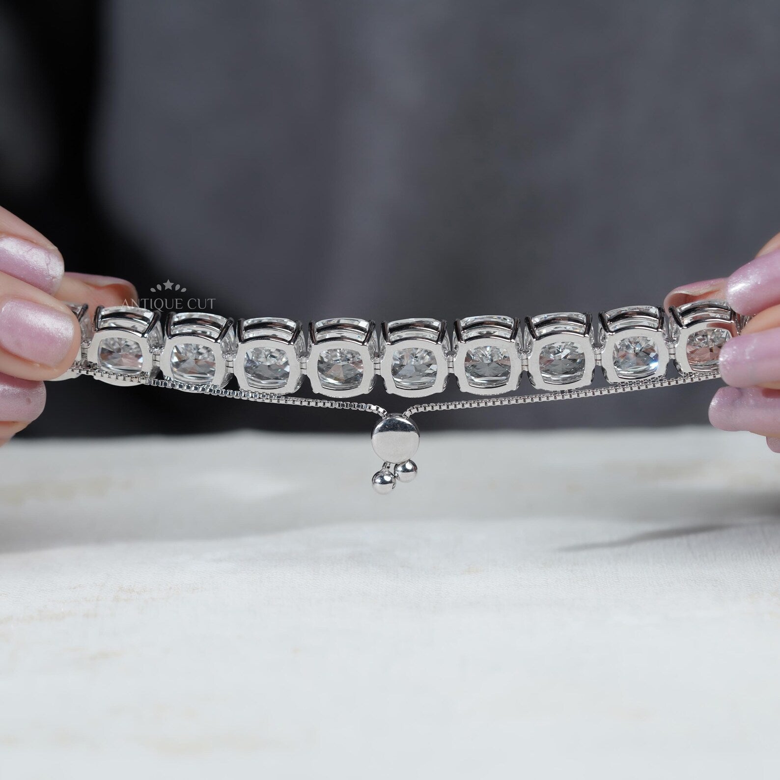 Silver bracelet with large gemstones on a light blue background