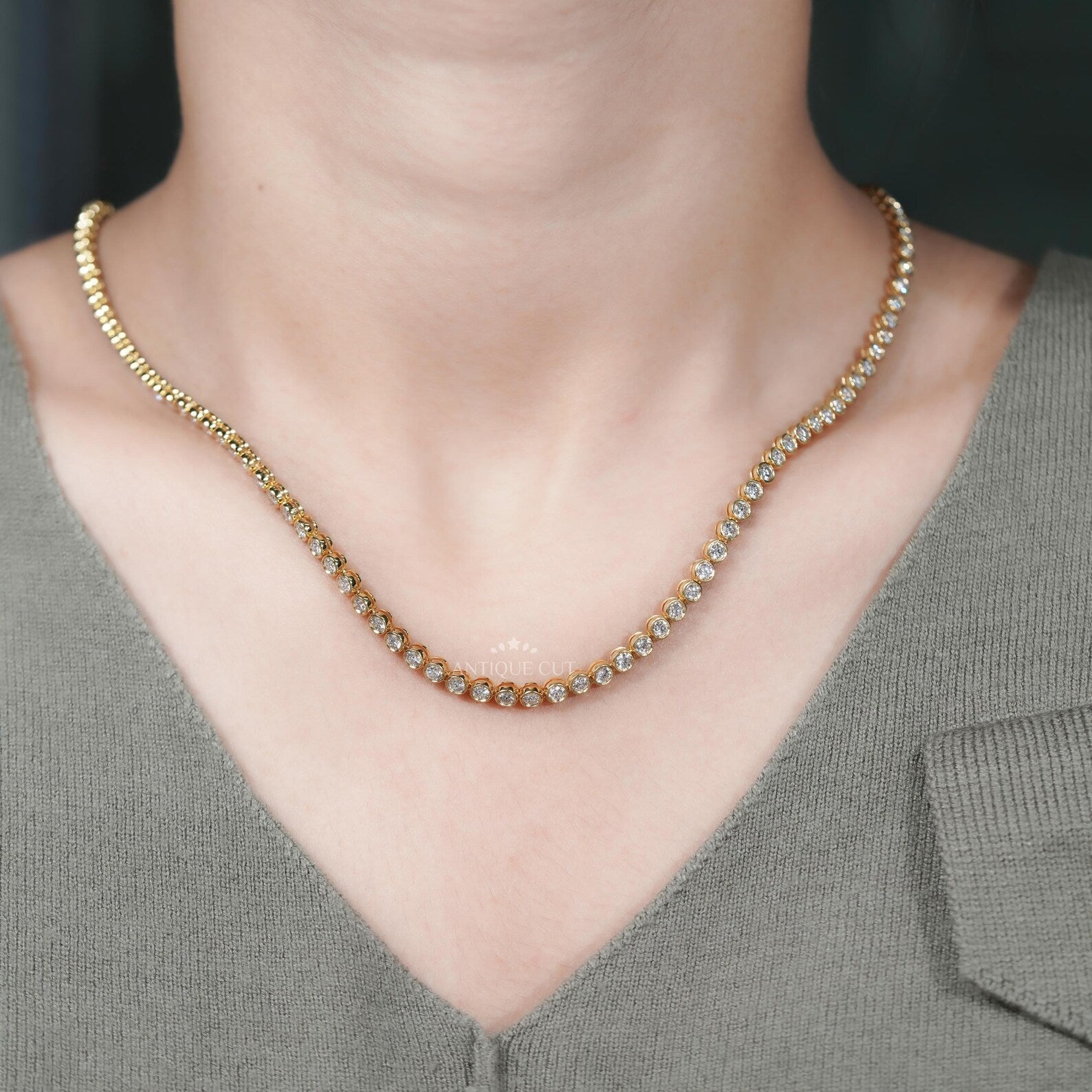 Gold necklace with diamonds on a person's neck