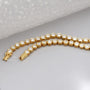 Gold necklace with diamonds on a person's neck