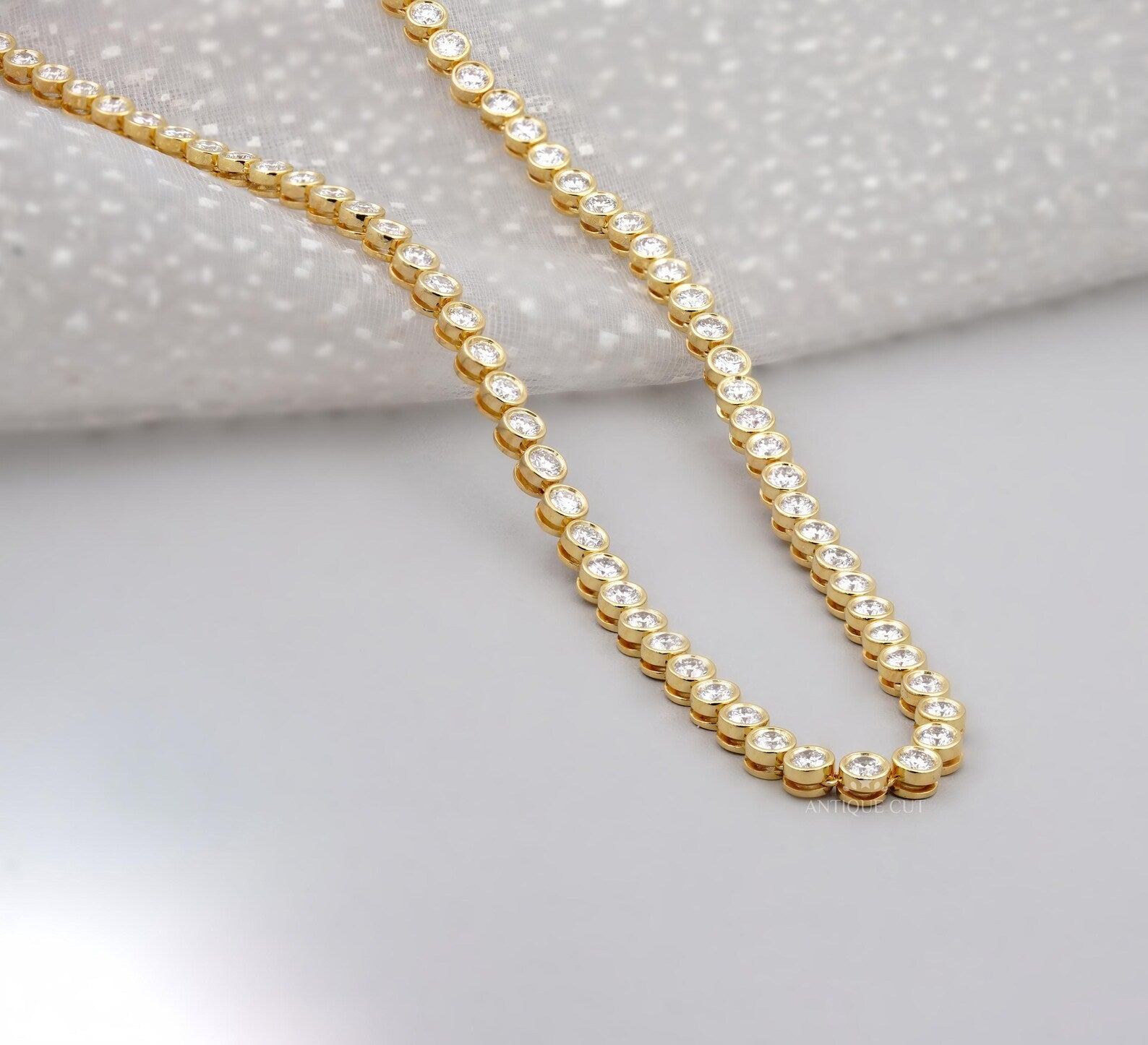 Gold necklace with diamonds on a person's neck