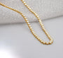 Gold necklace with diamonds on a person's neck