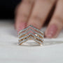 Gold and diamond ring on a light gray background

