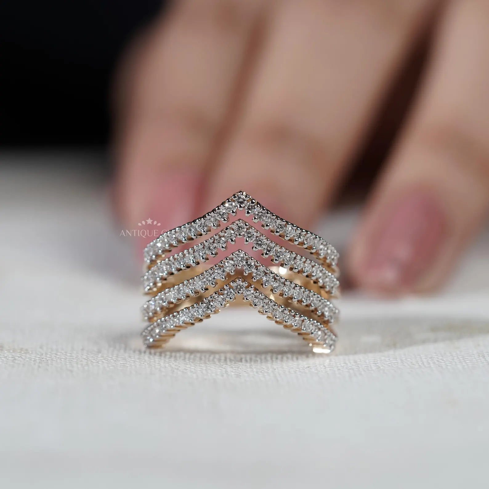 Gold and diamond ring on a light gray background

