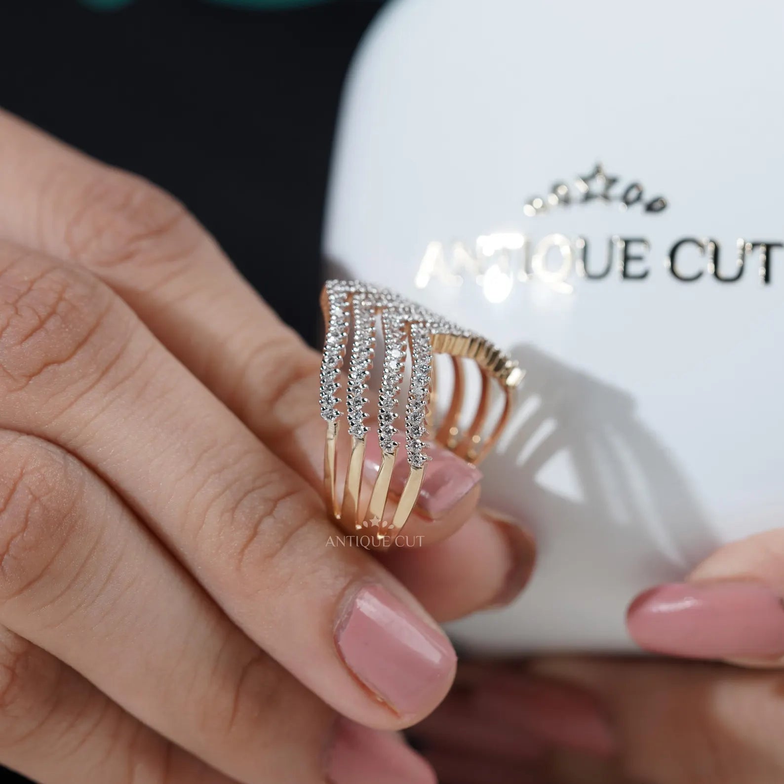 Gold and diamond ring on a light gray background

