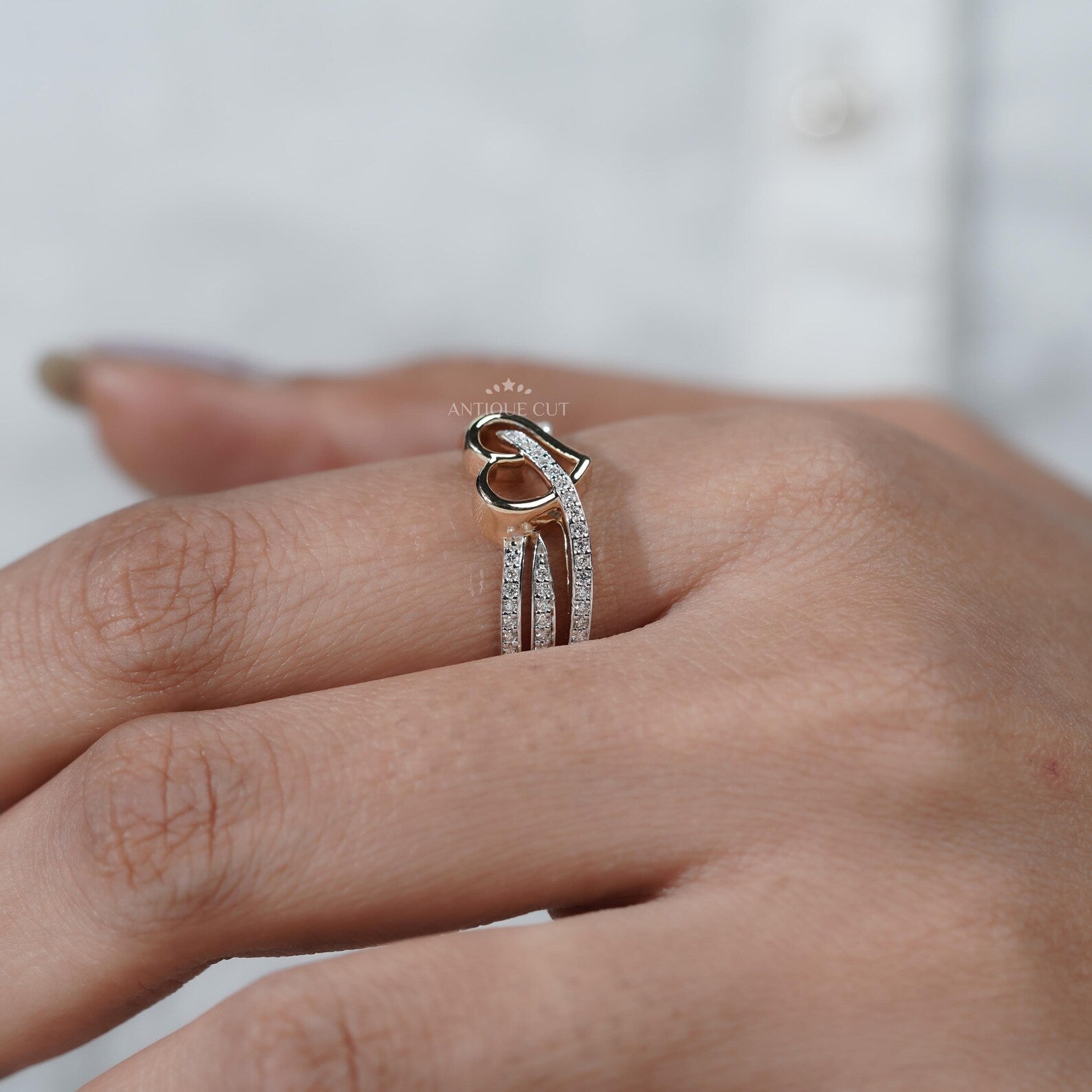 Silver ring with a heart design on hand