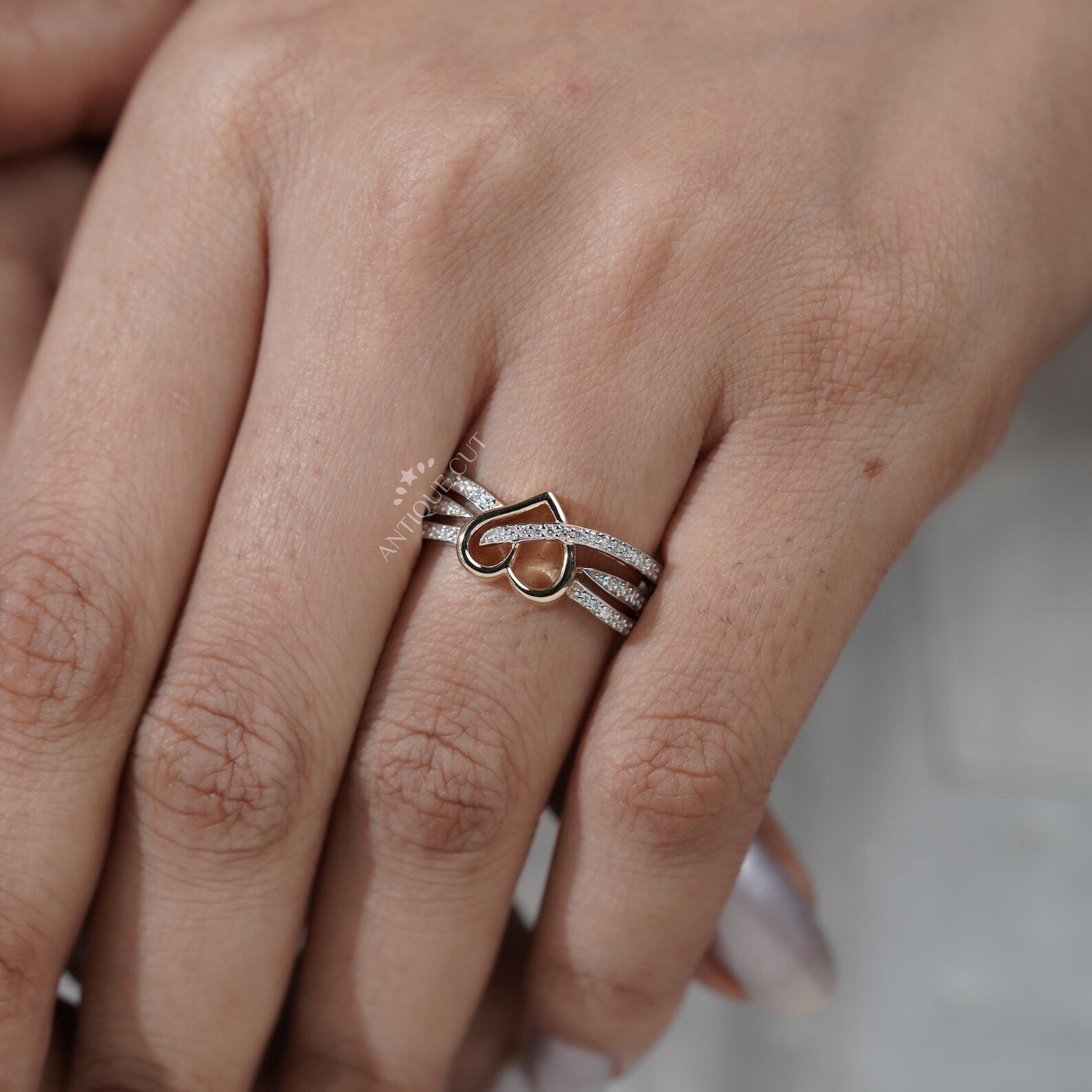 Silver ring with a heart design on hand