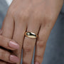 Gold ring on a light gray background

