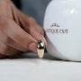 Gold ring on a light gray background

