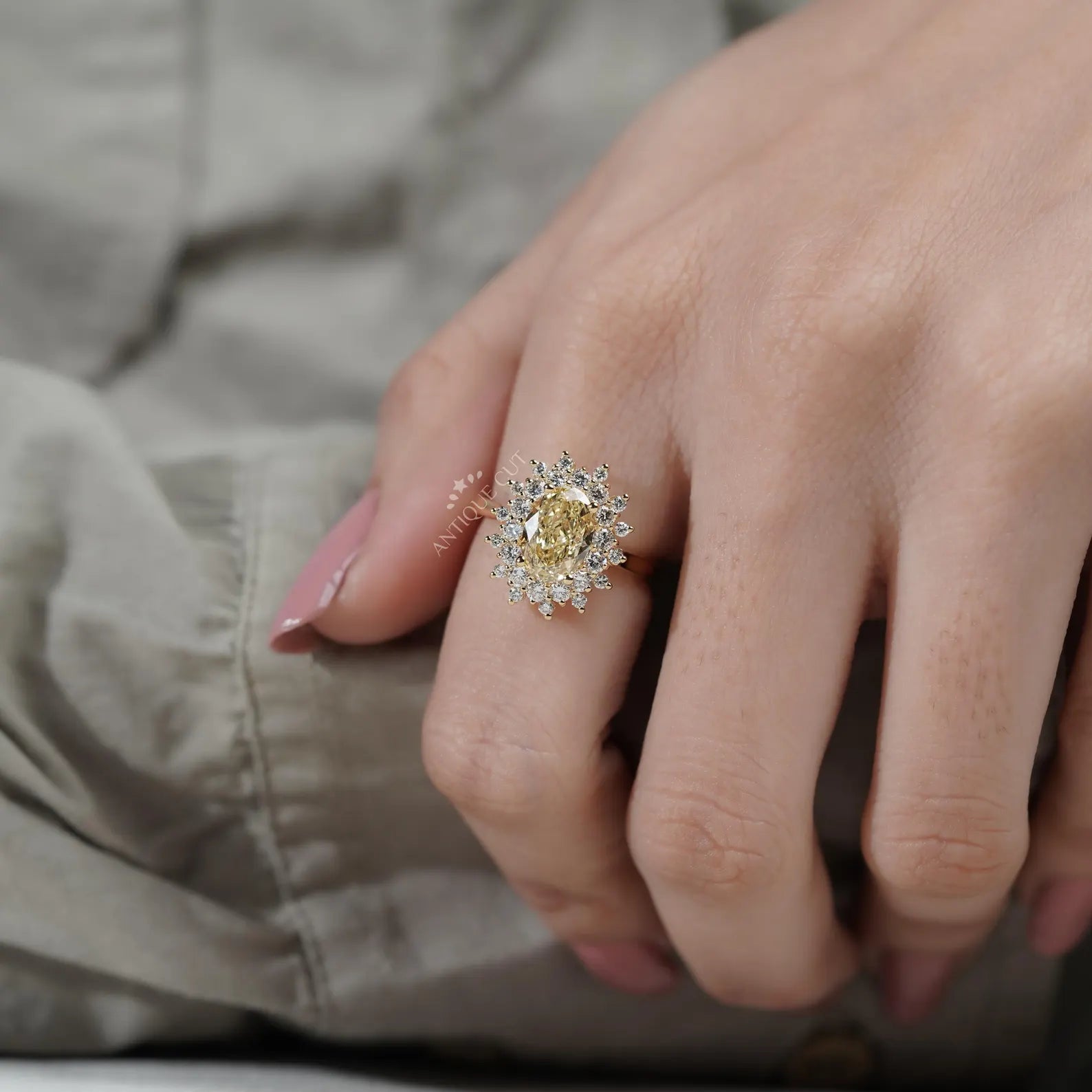 Close-up of a hand wearing a gold ring with a diamond ring