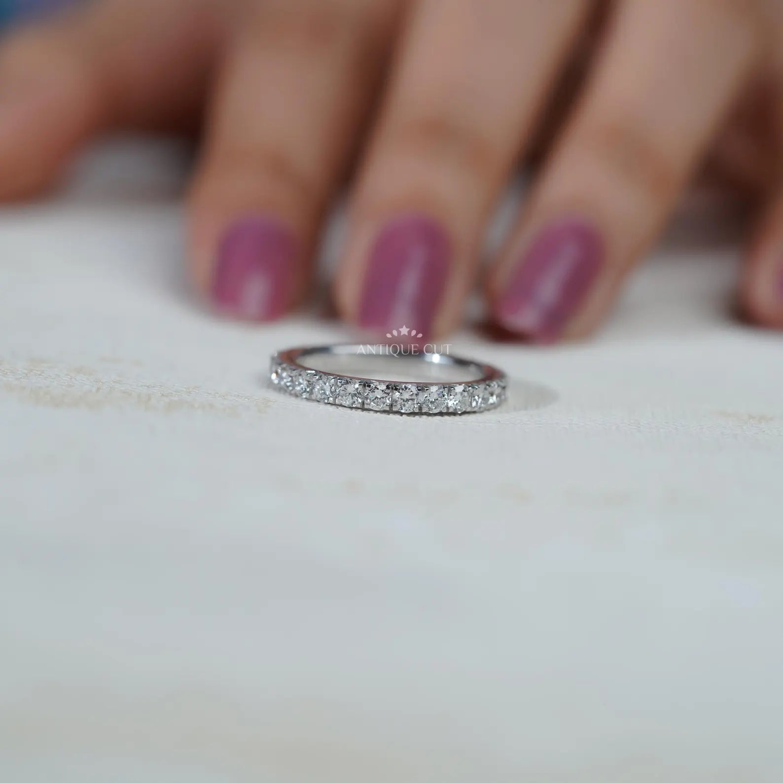 Silver ring with diamonds on a soft blue background

