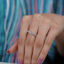 Silver ring with diamonds on a soft blue background


