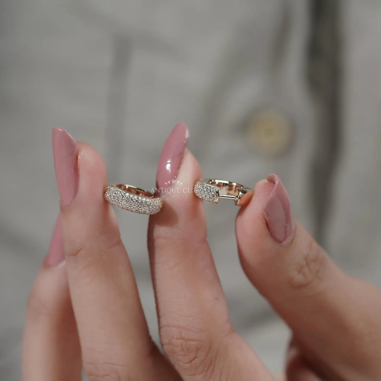 Close-up of a person wearing a gold hoop earring