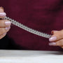 Diamond bracelet with emerald-cut diamonds on a gradient blue and gray background
