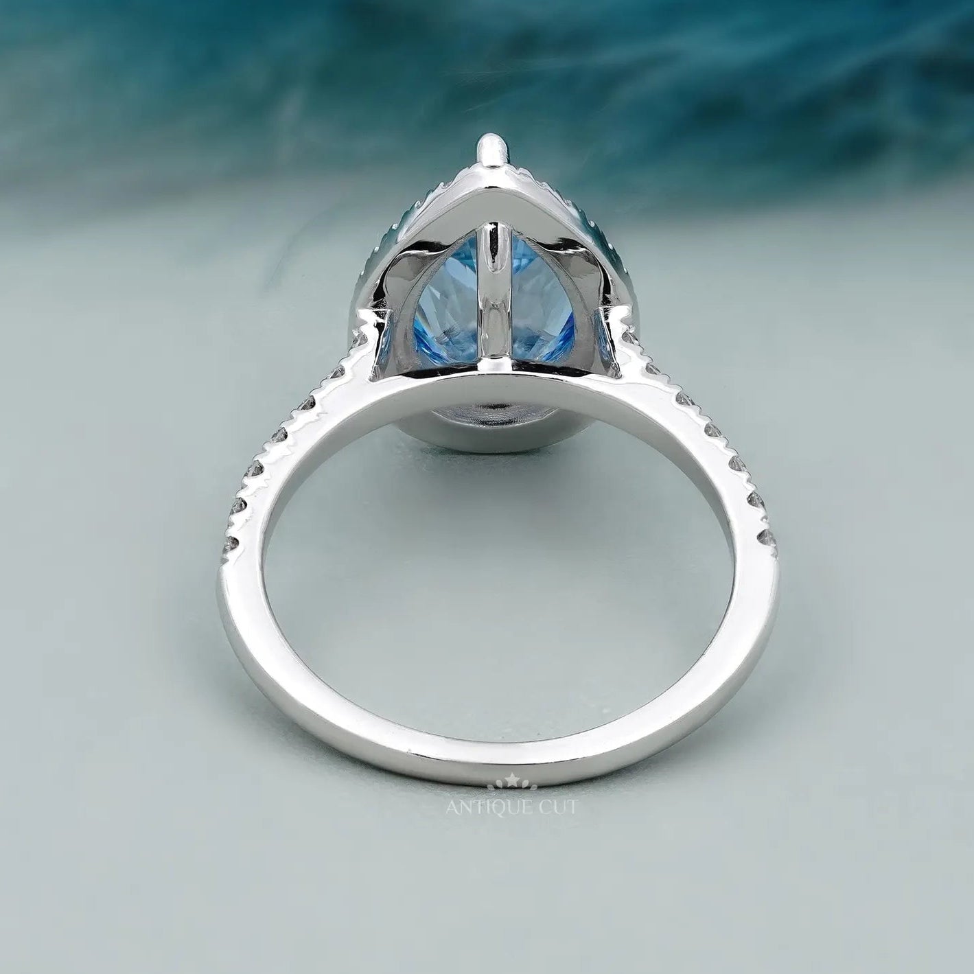 Teardrop shaped halo diamond ring with pave diamond band