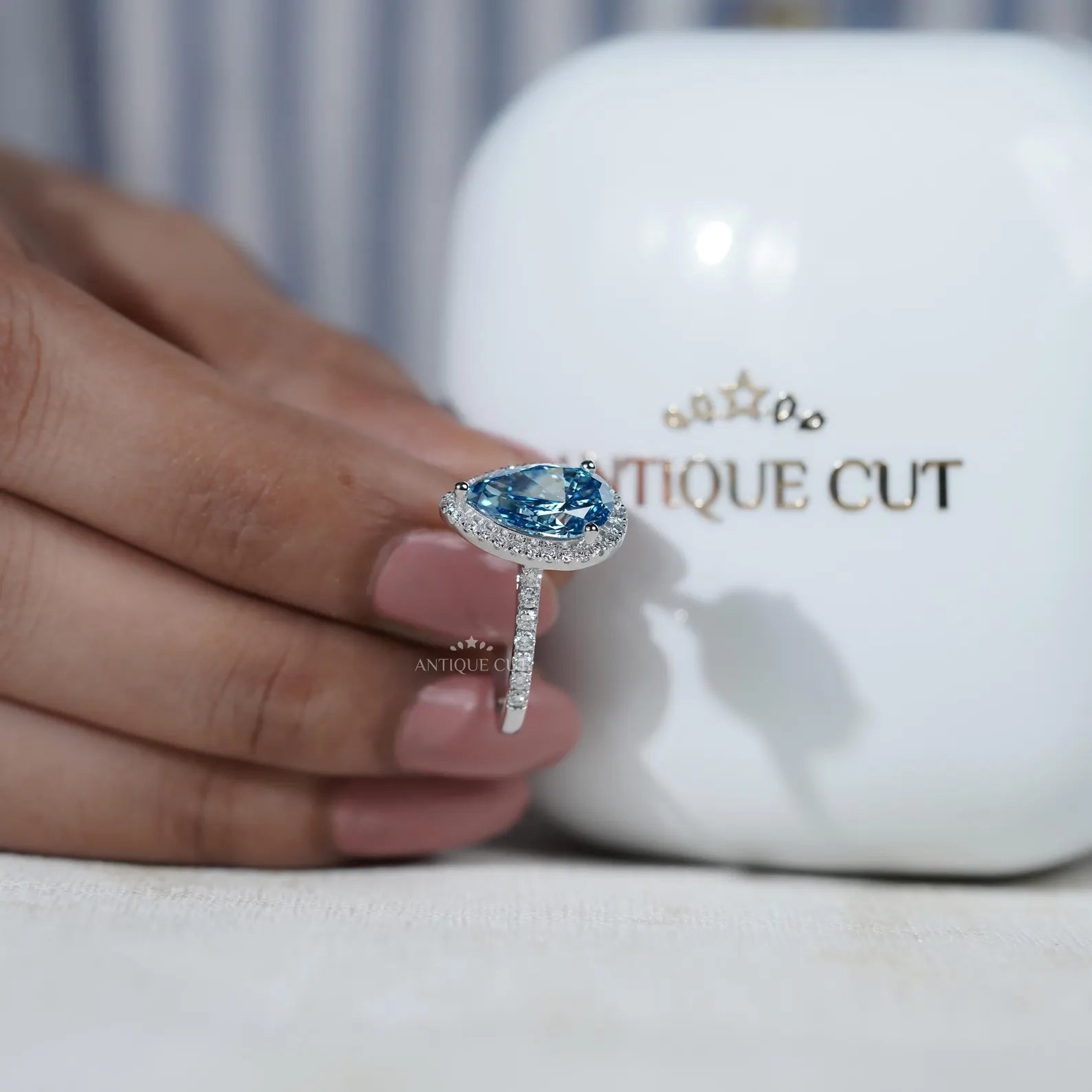 Blue lab grown diamond halo engagement ring with pave band