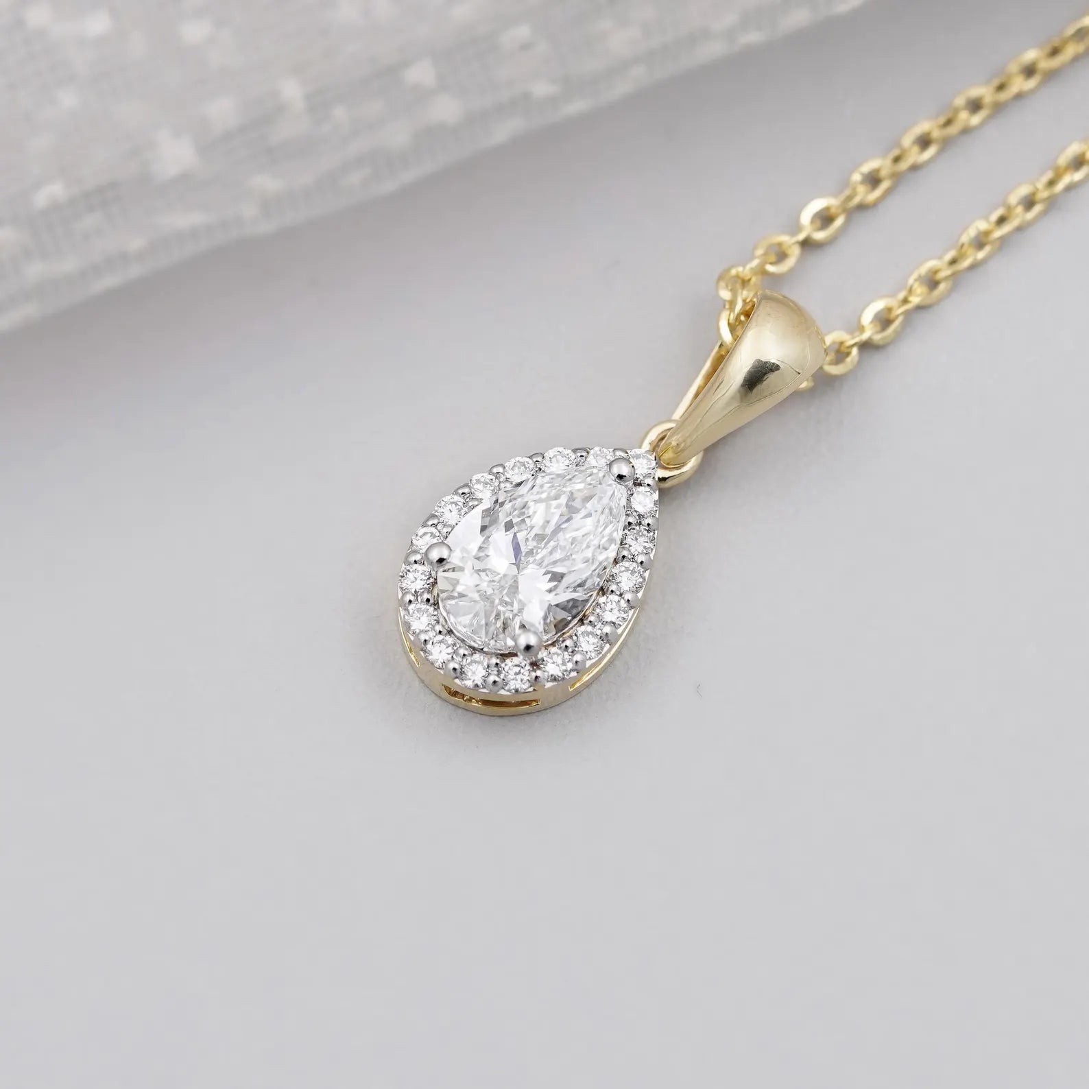 Pear cut pendant with round cut halo setting